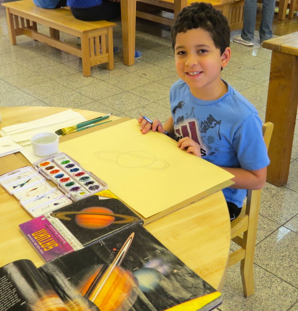 A fourth grader learned about the Solar System and has decided to illustrate his work with water colors.