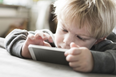 26249508 - little kid playing game on smart phone